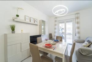 a dining room with a table and a couch at SANNY APARTMENT IN THE CITY CENTER in Sanremo