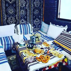 stół z talerzami jedzenia na łóżku w obiekcie Casa Plasa Grande CHAOUEN w mieście Szafszawan