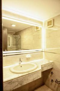 a bathroom with a sink and a mirror at Mar Charbel Hotel Cairo in Cairo