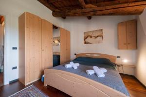 een slaapkamer met een bed met twee handdoeken erop bij Al Castello - Ein Urlaub in einer eleganten Residenz mit Schwimmbad, umgeben von Grün und Ruhe in Lazise