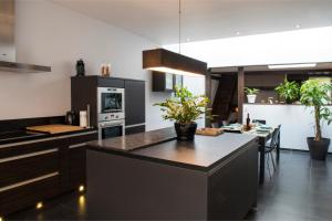a kitchen with a large island in the middle at Hottonruy 4 in Stavelot