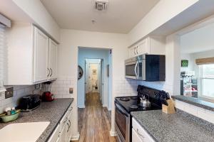 a kitchen with white cabinets and a stove top oven at Nash-Vegas Oasis in Nashville