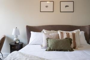 a bedroom with a bed with white sheets and pillows at The King in Fowey