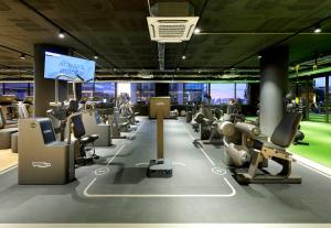 a gym with a bunch of treadmills and machines at Hesperia Barcelona Sant Just in Sant Just Desvern