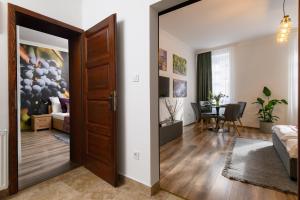a room with a door leading to a living room at Várvédőház Apartmanok Eger in Eger