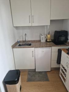a small kitchen with a sink and a microwave at Beach Life Carabassi Beach Gran Alacant in Gran Alacant +29 photos