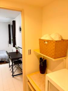 a kitchen with a table and a basket on the wall at IXO Ts3 in Tokyo +8 photos