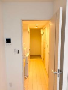 an open door to a hallway in a room at IXO Ts3 in Tokyo