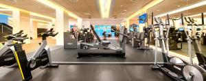 a gym with treadmills and elliptical machines at Hesperia Sevilla in Seville