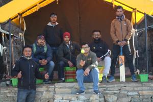 a group of men posing for a picture in a tent at Camp Moonlight beauty in Nainital