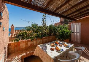 a table with plates of food on a patio at PGS IMMOBILIARE SRLS – Pagello D – Trilocale vista mare– La Maddalena in Casale Azara