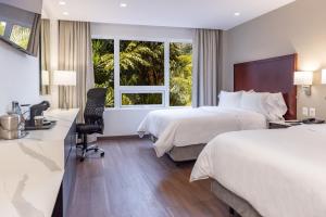 een hotelkamer met 2 bedden en een bureau bij Hotel Biltmore in Guatemala
