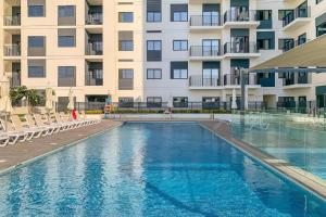 a swimming pool in front of a building at Lux BnB Nook -2 I City Views in Dubai