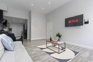 a living room with a couch and a table at Harwich Luxury Suite in Harwich