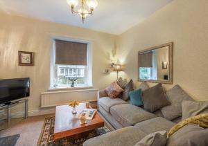 a living room with a couch and a tv at Viaduct View in Ingleton