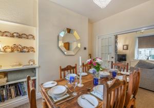 a dining room with a wooden table and chairs at Viaduct View in Ingleton
