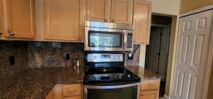 a kitchen with a microwave above a stove at Luxury 3-Bedroom Home near Beaches with Pool in Vero Beach