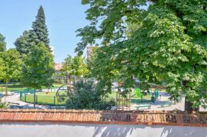 a park with a playground and trees in the background at Sleep'In Cities Le Saphir Balnéo in Albi