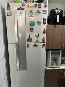 a refrigerator in a kitchen with magnets on it at 2 Quartos Aconchegante - Cohama in São Luís