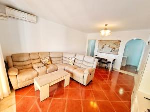 a living room with a couch and a table at Residencial Alcaraván, Isla Canela - By AC REAL in Isla Canela