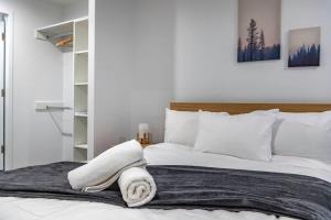 a bedroom with a bed with towels on it at Bliss In The Heart Of Canberra in Canberra
