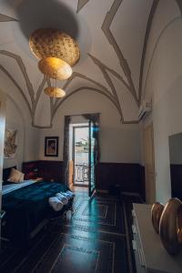a bedroom with a bed and two chandeliers at Verso Oriente in Brindisi