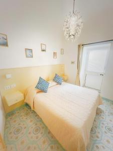 a bedroom with a bed and a chandelier at B&B Il Paradiso di Capri in Anacapri