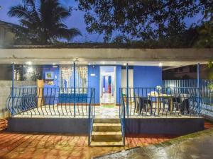a blue house with a table and chairs at Blue Lagoon 2bhk in Lonavala