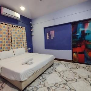 a bedroom with a bed and a large screen at Blue Lagoon 2bhk in Lonavala