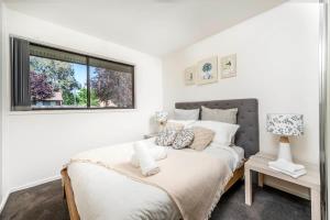 a bedroom with a bed and a window at Awesome family House & Studio in Narrabundah
