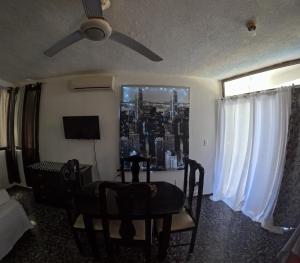 - un salon avec une table et un ventilateur de plafond dans l'établissement Hotel El Legendario, à Sosúa