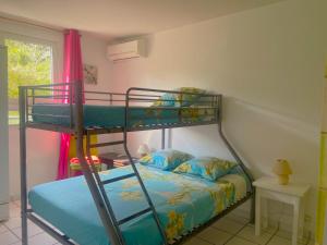 a bedroom with two bunk beds and a window at Madi Sun - Spacieux - Plage 250m in Les Trois-Îlets