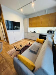 a living room with a couch and a kitchen at Apartment Targowa L11 in Lublin