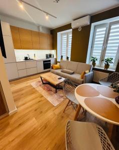 a living room with a couch and a table at Apartment Targowa L11 in Lublin