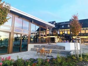 a building with a table and chairs in front of it at Der schöne Asten - Resort Winterberg in Winterberg