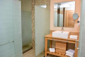a bathroom with a sink and a shower at The Tropical at LHVC, Puerto Plata in San Felipe de Puerto Plata