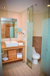 a bathroom with a sink and a toilet at The Tropical at LHVC, Puerto Plata in San Felipe de Puerto Plata