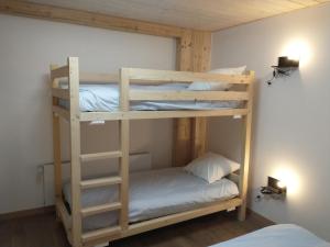 a bunk bed in a room with two bunk beds at La Châtelaine in La Rixouse