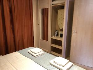 a bedroom with two folded towels on a bed at Turquoise Beachside Apartments in Dobrota