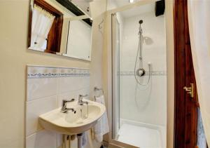 a bathroom with a sink and a shower at The Dollery in Horsham Saint Faith