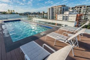 a swimming pool on the roof of a building at Stylish Apartment with Rooftop Pool in Brisbane