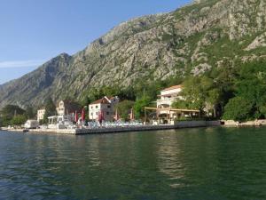 a small town on the shore of a body of water at Turquoise Beachside Apartments in Dobrota