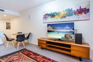 a living room with a large flat screen tv at Urban Luxury - Discover this City Escape in Brisbane