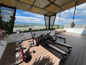 a gym with three bikes parked on a deck at Medju - Elegant Apartment in Guatemala