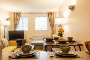 a living room with a table with dishes on it at Updated & central 2 bedroom Chester apartment - for up to 6 in Chester