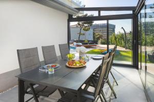 een eettafel met een fruitschaal erop bij NEW Stylish 5-bedroom villa Aride with pool, sea views in Podstrana