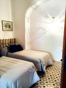 a bedroom with two beds and an archway at 7 bedrooms villa with private pool enclosed garden and wifi at Cordoba in Córdoba