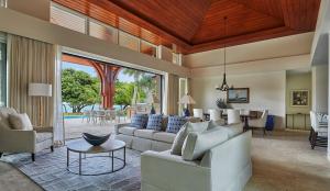 a living room with white couches and a table at Oil Nut Bay in Virgin Gorda +197 photos