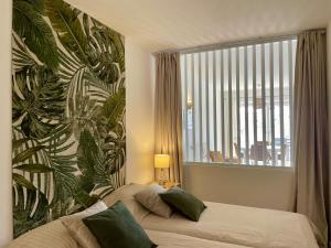 a bedroom with a bed and a large window at RosaMar apartment sea view and pool in Albufeira