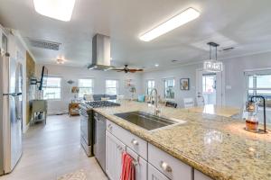 a kitchen with a sink and a counter top at Lovely Crystal Beach House with Deck Walk to Ocean! in Crystal Beach